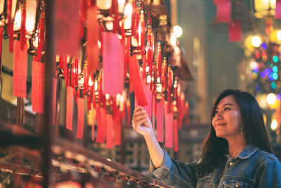 Portrait of woman at illuminated temple