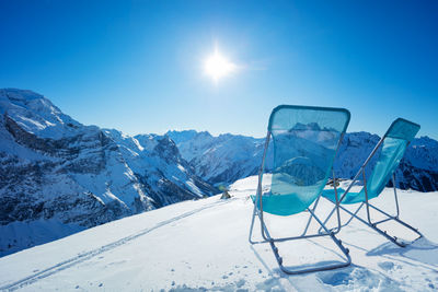 Scenic view of snowcapped mountains against clear blue sky