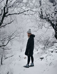 Woman standing on snow covered land