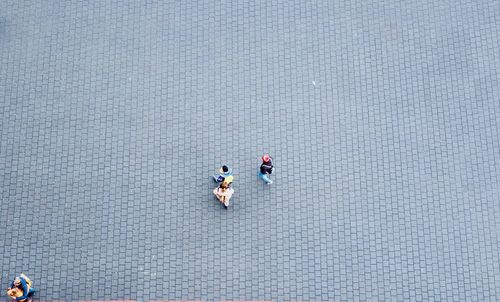 High angle view of people walking on zebra crossing