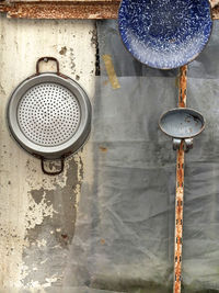 Close-up of old rusty metal hanging against wall