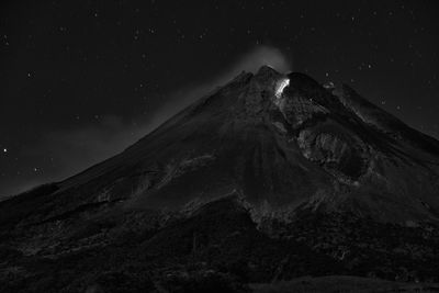 Scenic view of snowcapped mountain against sky at night