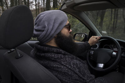 Portrait of young man in car