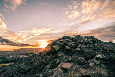 Scenic view of cliffsidd against sky during sunset