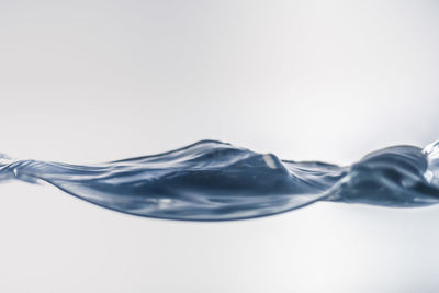 Close-up of water splashing against white background