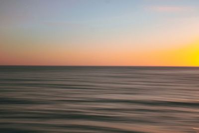 Scenic view of sea against clear sky during sunset