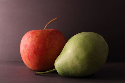 Close-up of apples on table against black background