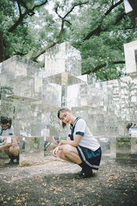 Side view of woman sitting at park