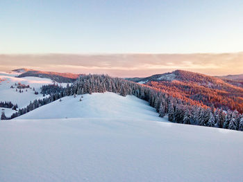 Scenic view of mountains against clear sky during winter