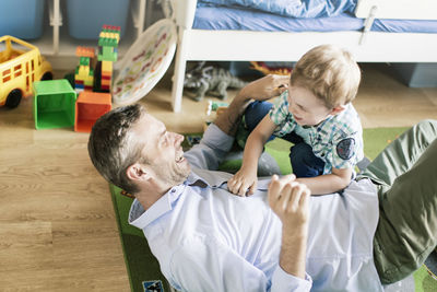 Happy father and son playing at home