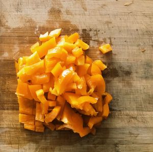 High angle view of yellow bell peppers on cutting board