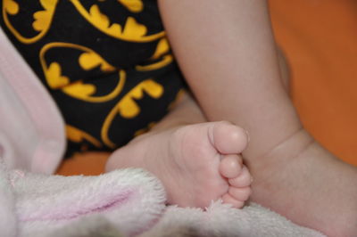 Low section of baby feet on bed