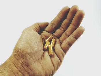 Close-up of man hand against white background
