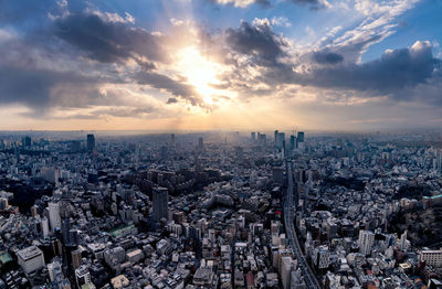 High angle view of cityscape against cloudy sky