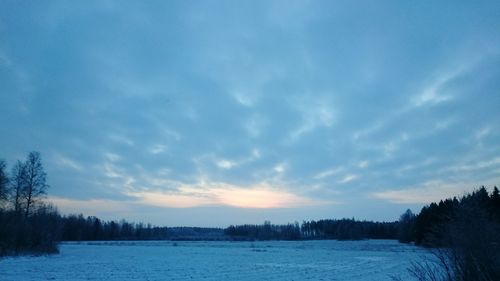 Scenic view of lake against cloudy sky