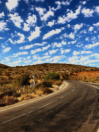 Road amidst landscape against sky