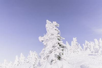 Low angle view of snowcapped mountain against clear sky