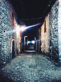 Street amidst buildings at night