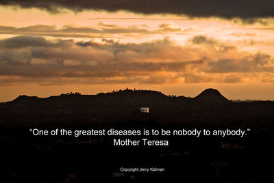 Silhouette text on mountain against sky during sunset