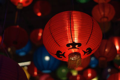 Close-up of illuminated lanterns hanging at night