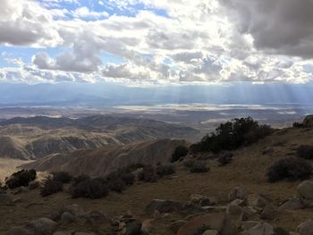 Scenic view of mountains against cloudy sky