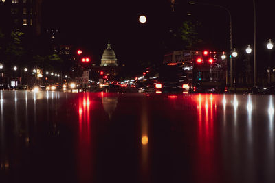 Reflection of illuminated buildings in river at night