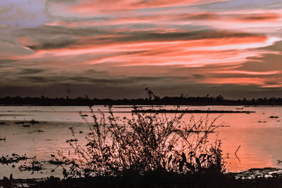 Scenic view of lake against sky during sunset