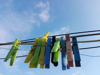 Low angle view of clothespin hanging on clothesline