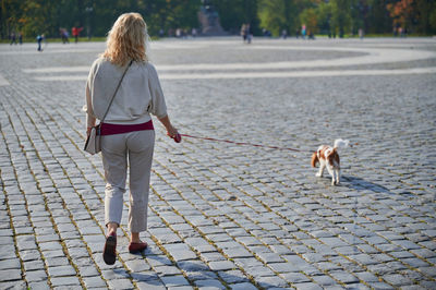 Rear view of woman walking on street