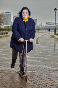 Portrait of man standing on footpath