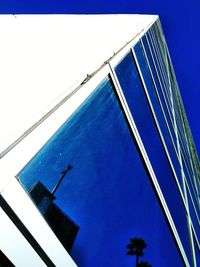 Low angle view of modern building against clear blue sky