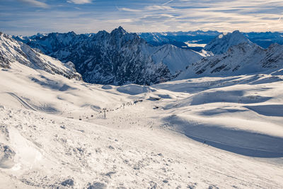 Scenic view of snowcapped mountains against sky