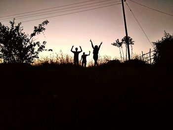 Silhouette of man against orange sky