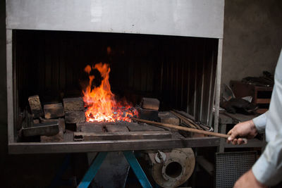 Man preparing fire on barbecue grill