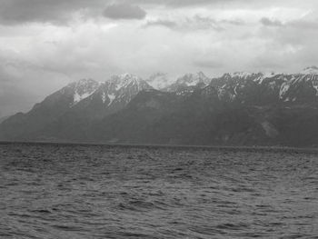 Scenic view of sea and mountains against sky