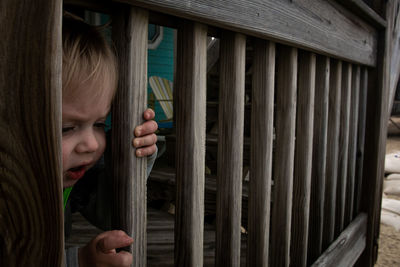 Portrait of a girl looking through window