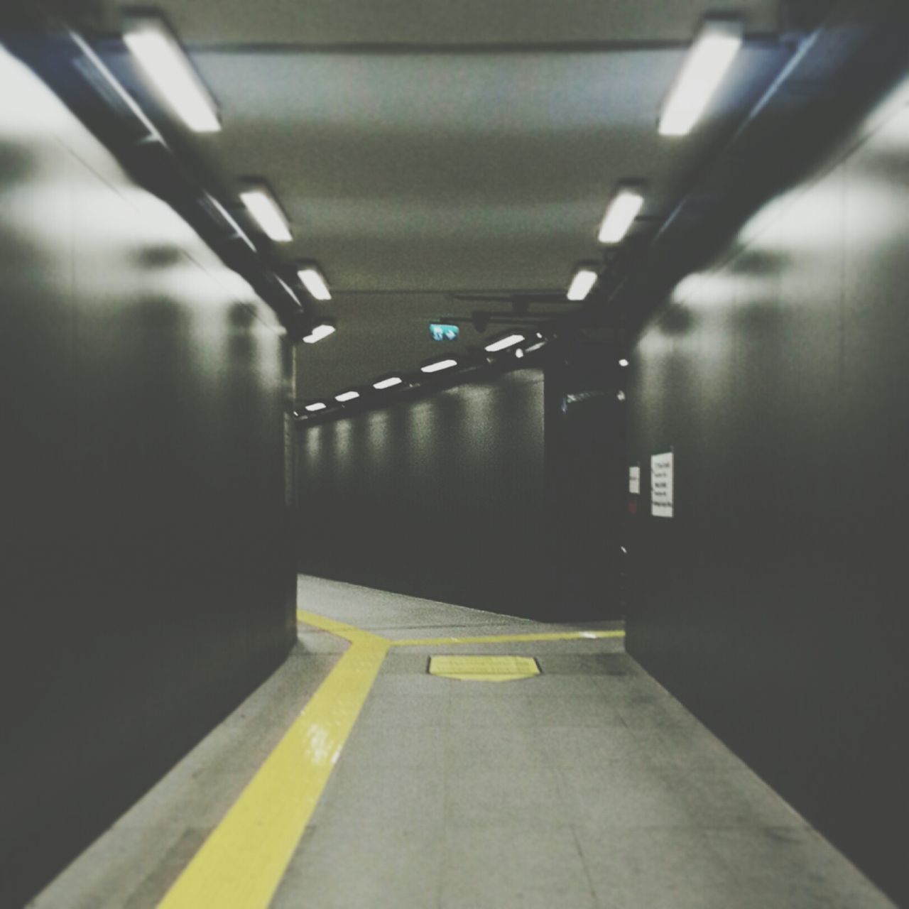 indoors, illuminated, empty, ceiling, lighting equipment, flooring, the way forward, absence, corridor, tiled floor, built structure, architecture, wall - building feature, diminishing perspective, subway, no people, floor, light - natural phenomenon, interior, wall