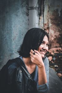 Portrait of young woman using mobile phone