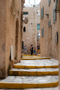 People walking on staircase of building