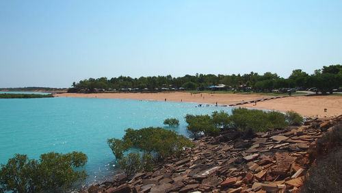 Scenic view of beach against clear blue sky