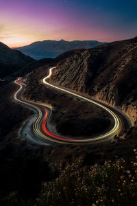 High angle view of light trails on road against sky at night