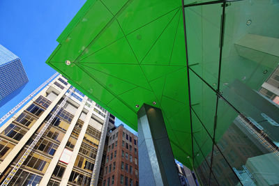 Low angle view of modern buildings against blue sky