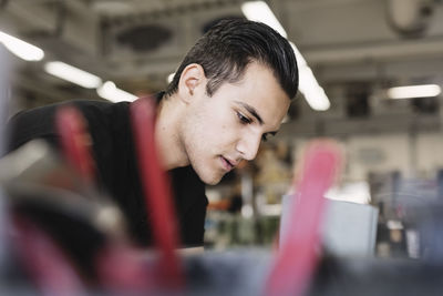 Side view of young man studying in training class