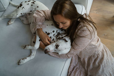 High angle view of woman lying down on bed