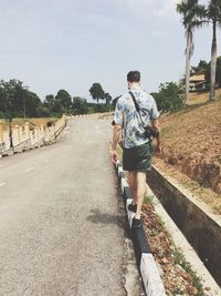 Full length of woman standing on tree trunk