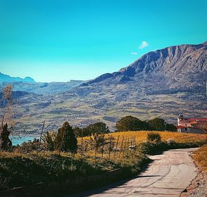 Scenic view of mountains against blue sky