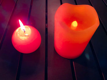 High angle view of lit candle