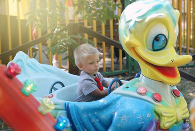 Cute boy playing with toy on playground