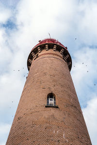 Low angle view of lighthouse on building against sky