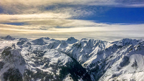 Scenic view of snowcapped mountains against sky